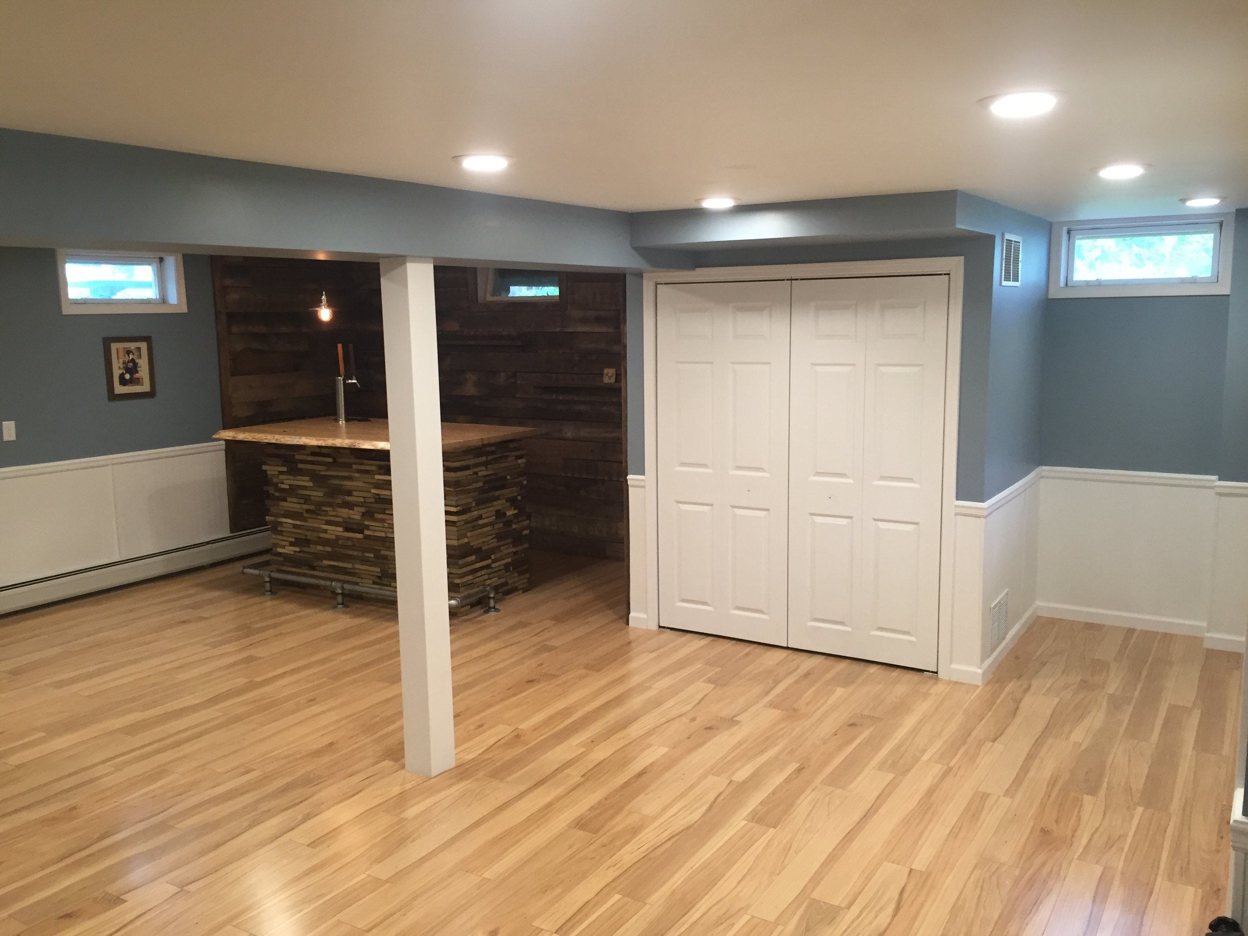  The basement remodel included custom closets, cabinetry, laundry area, a new floor as well as the bar corner. 