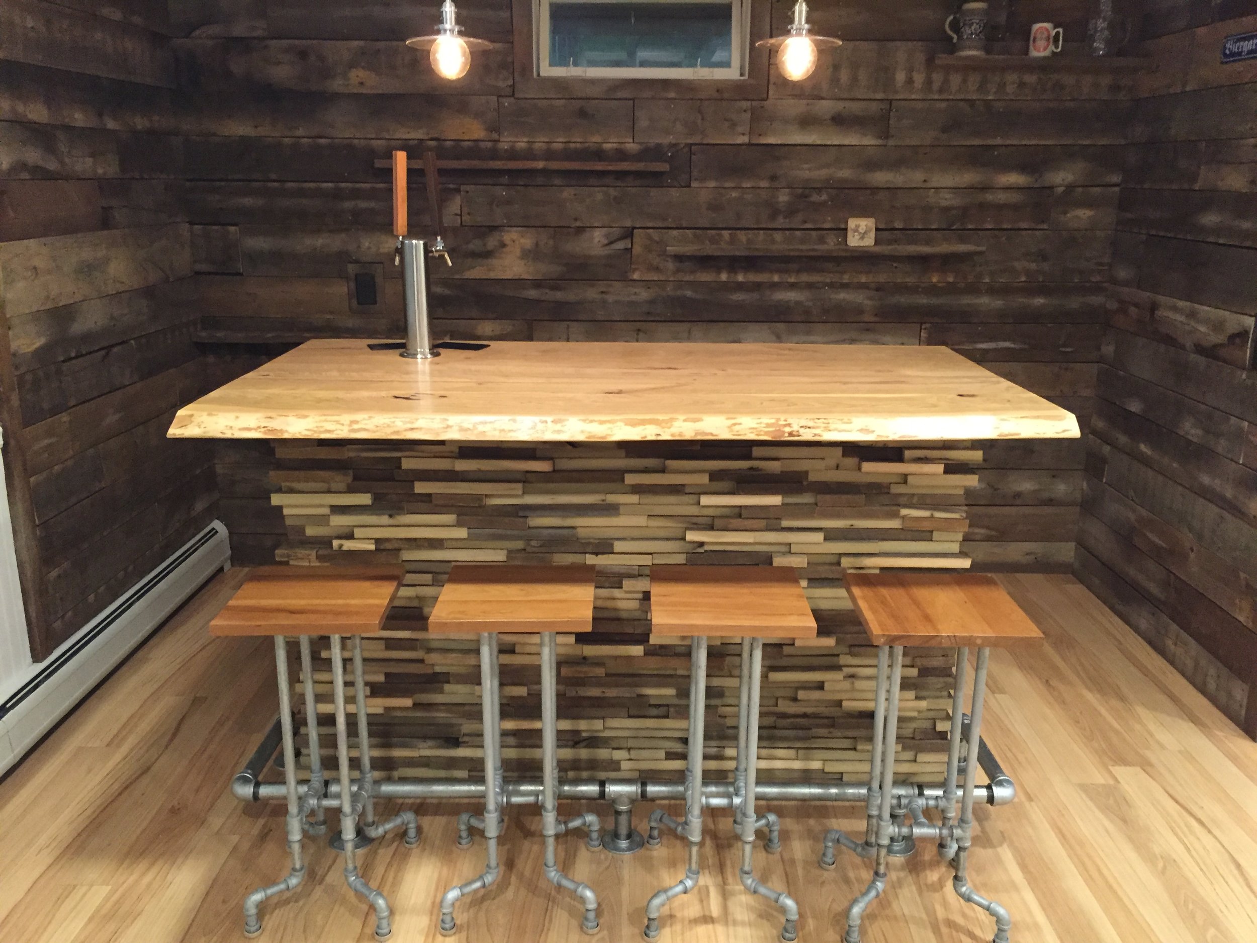  The homeowner had created stools with pipes for legs, so the JFB crew created a pipe fitting toekick on the bar to match. 