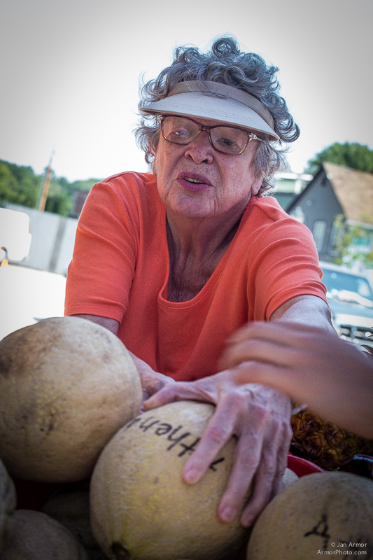  A woman reachies for a squash at the Jonnycake Center's "Farmers Market." Growers and Super Markets from around the area donate fresh produce to help feed those in need. 