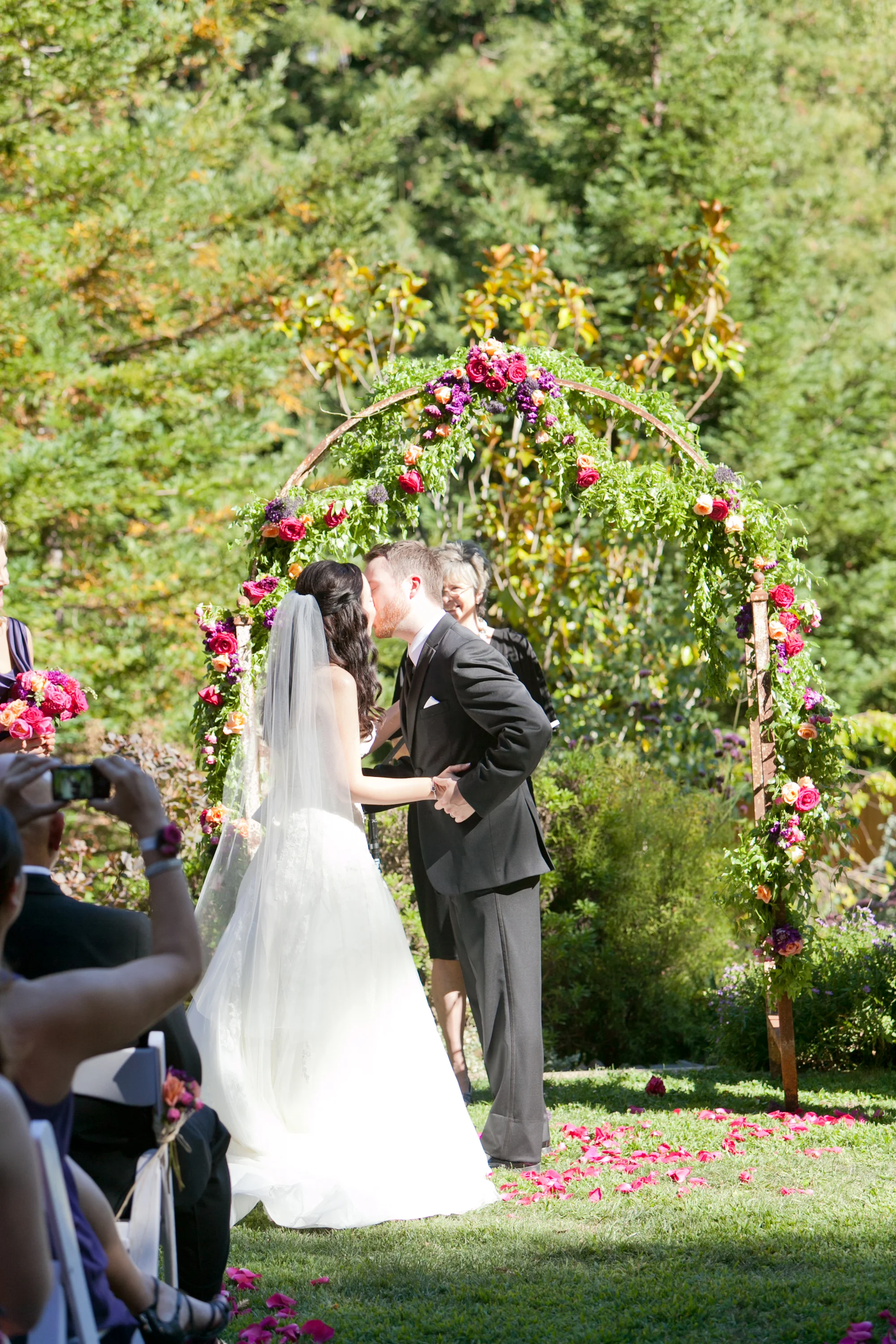 bride and groom kiss at redwood hills garden