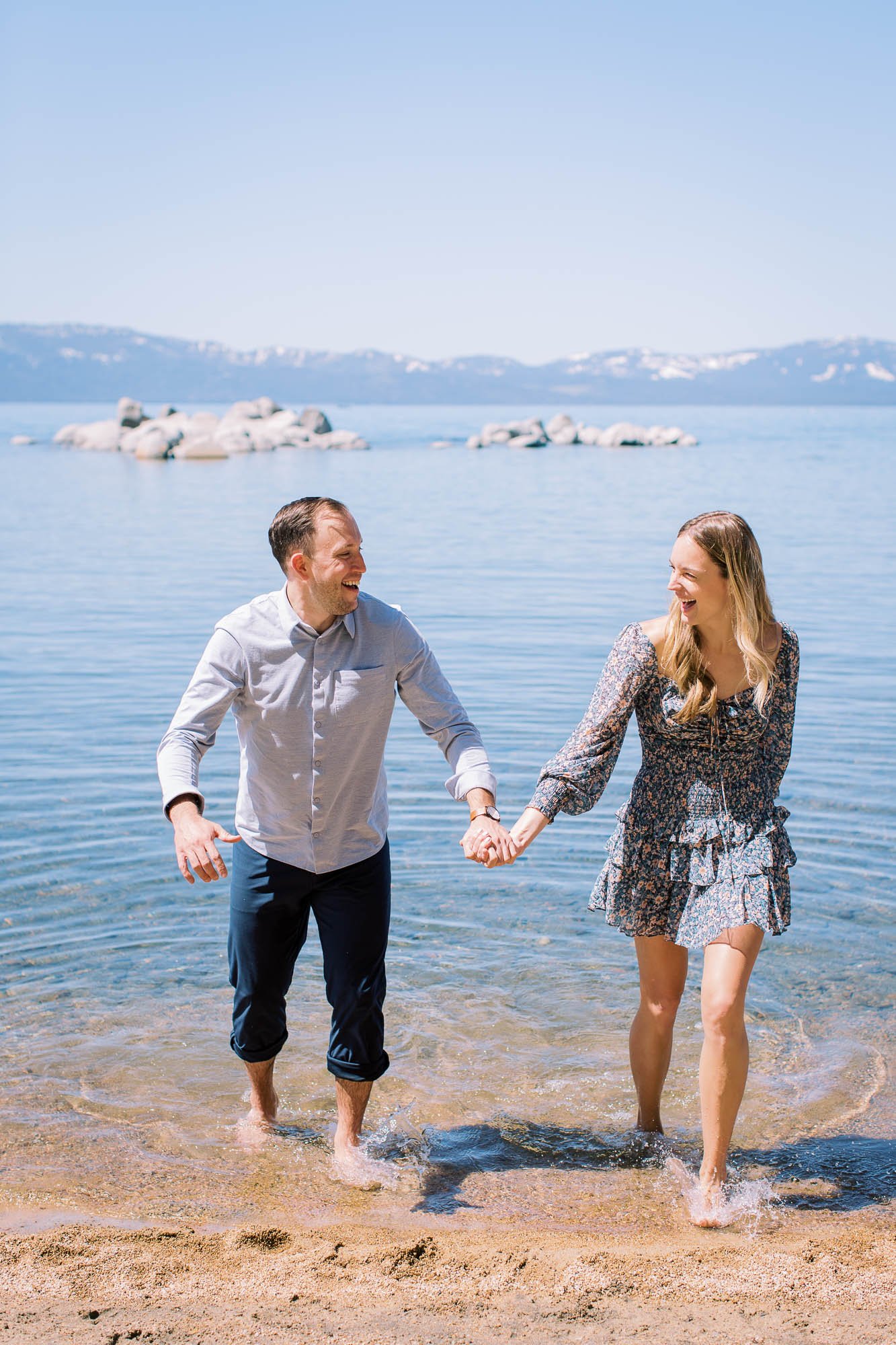 engaged couple running out of tahoe