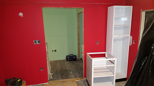 The broom closet and additional cabinet. A custom bookshelf will be installed in the space to the left of the broom closet.