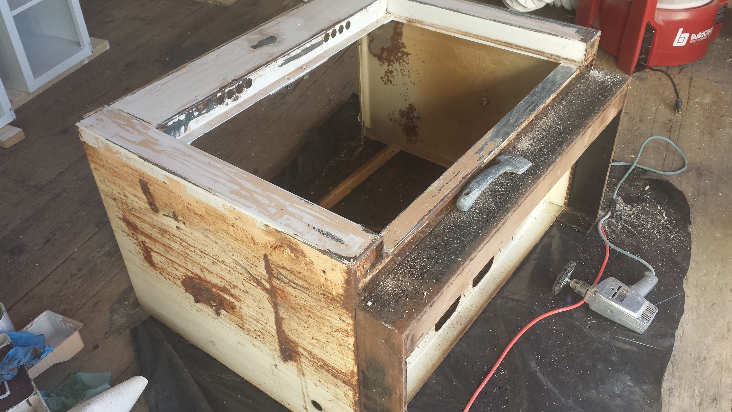 The sink base in its original, rusty condition.