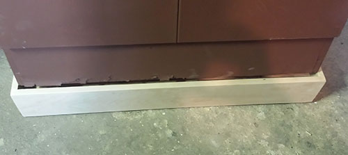 The new base, not quite in place. You can see the rough, rusted edges on the bottom of the cabinet itself.
