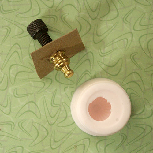 The silicone mold and the brass finial, ready for resin.