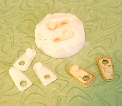 The silicone mold, newly molded spacers on the left and old spacers on the right.