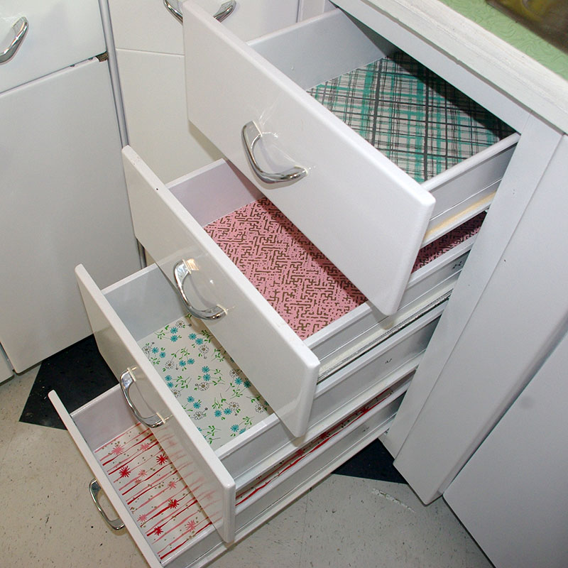 Fun vintage Con-Tact paper. I used a different pattern for every drawer.