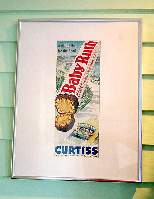 A framed magazine ad for Baby Ruth, from the Curtiss Candy Company (no relation). This currently hangs in our new eating area.