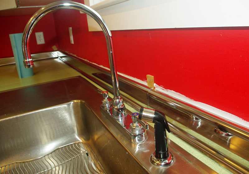 The backsplash shimmed and caulked