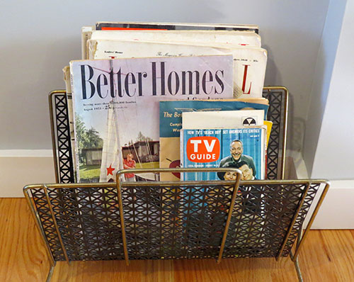 No mid-century living room would be complete without a magazine rack, filled with vintage magazines.