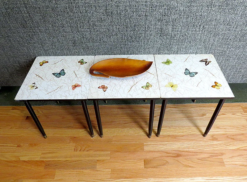 These stacking butterfly tables were in my Dad's home growing up. They make a great table behind the couch.