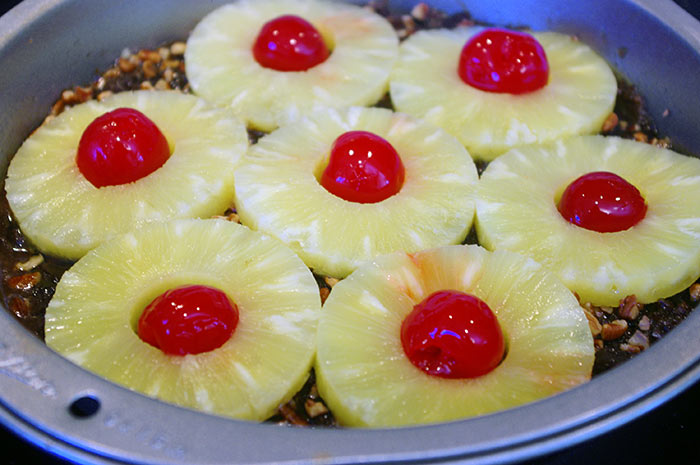 Pineapples and cherries arranged and ready for batter.