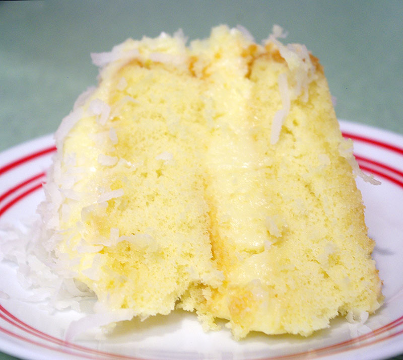A slice of coconut cake with coconut pastry cream