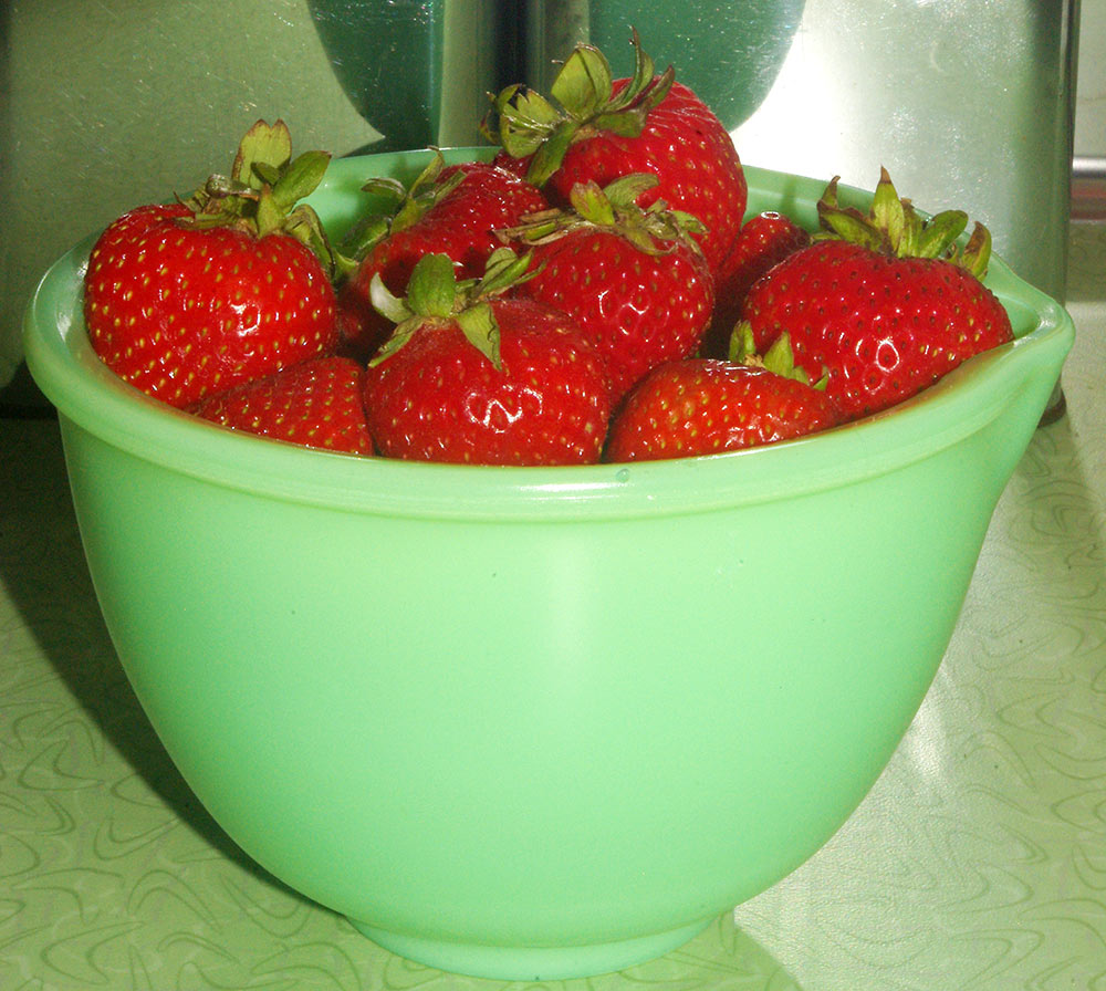 Fresh strawberries in a vintage jadeite bowl