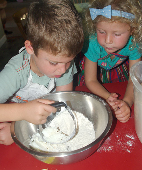 Caleb cutting shortening in with the dry ingredients