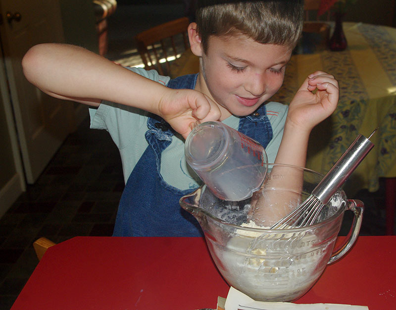Caleb pouring in the milk