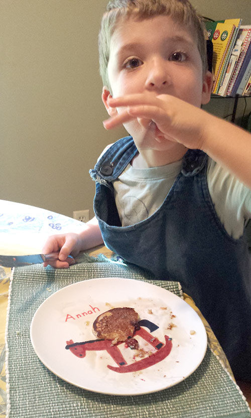 Caleb making short work of his dino pancake