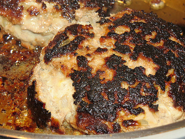 The burgers in the frying pan