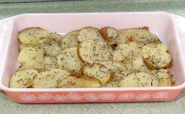 Sliced, cooked potato with a sprinkling of dried thyme