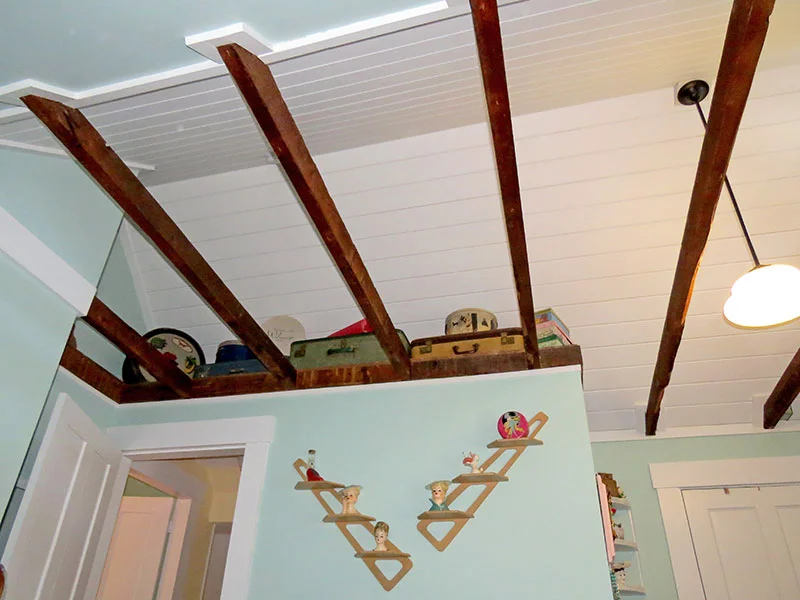 The vaulted ceiling with exposed original beams.