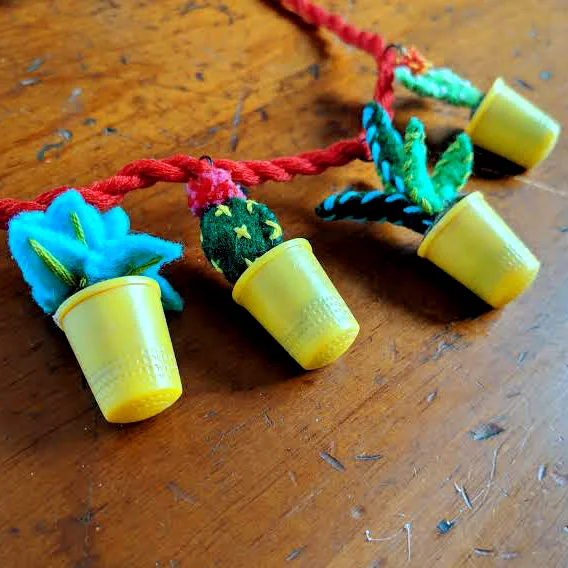 The finished potted plants necklace with plants and cacti