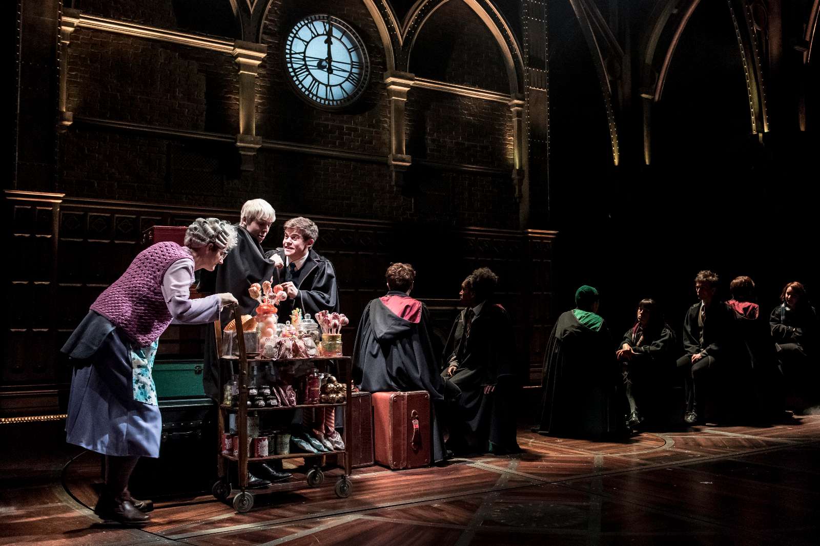 L-R Sandy McDade (Trolley Witch), Anthony Boyle (Scorpius Malfoy), Sam Clemmett (Albus Potter) and the cast of Harry Potter and the Cursed Child; Photo by Manuel Harlan - http://www.harrypottertheplay.com/