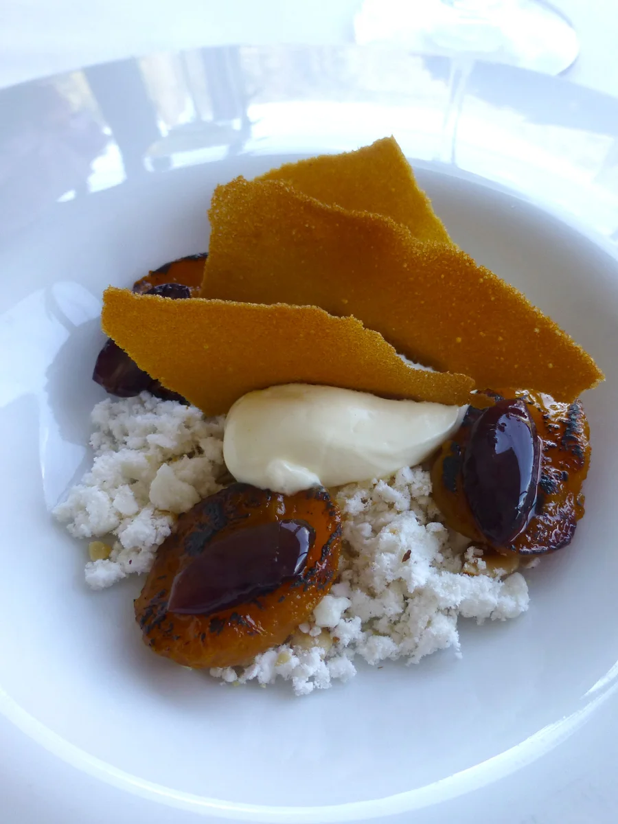 Dessert of roast peaches with a hazelnut crumb and creme fraiche 