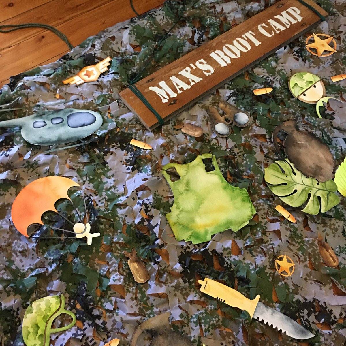 The backdrop was put together by sewing each motif onto the camouflage netting to secure the pieces in place. 