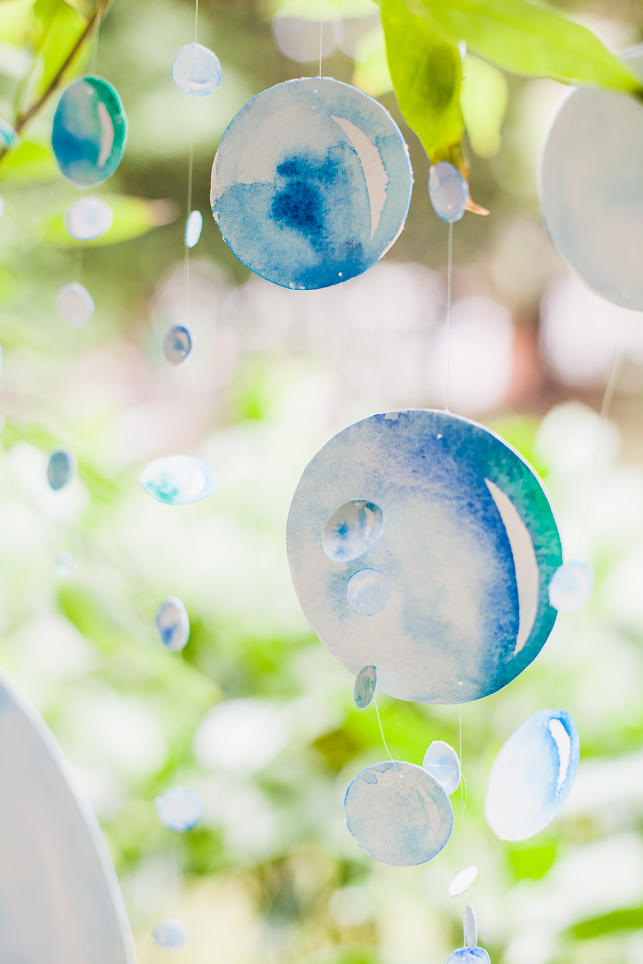 Each watercolour bubble was individually hand-painted on both sides and strung on fishing wire so that they could spin delicately through the air. 