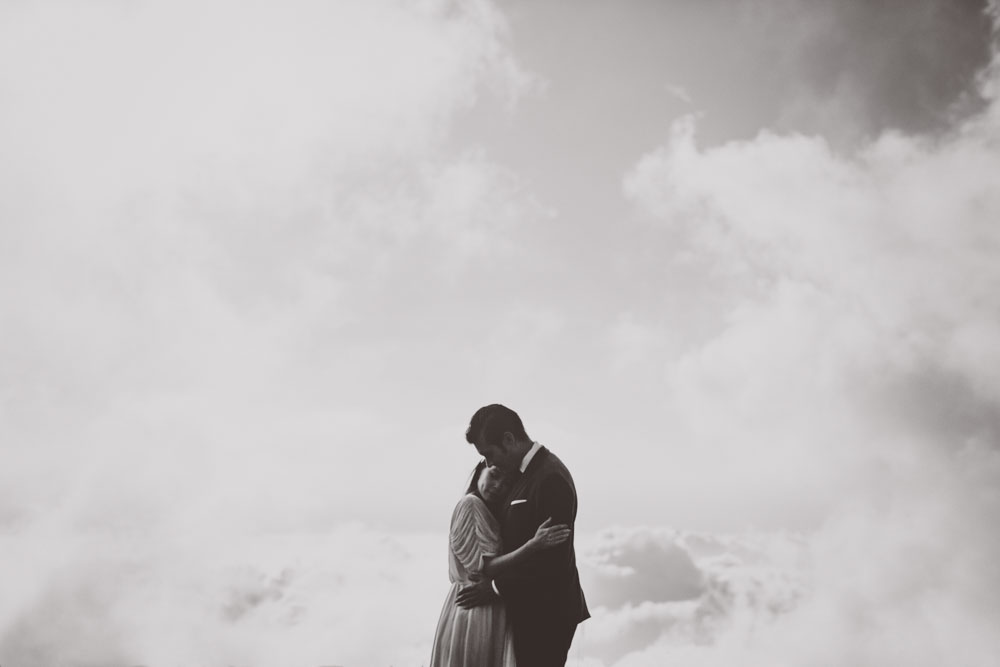 newlyweds on top of the world above the clouds