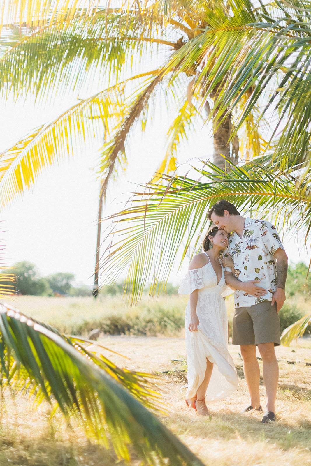  Top Maui Wedding photographer Angie Diaz Captures beautiful tropical engagement session with the perfect sun flare and romance your heart needed. Location: Palm Trees at Olowalu, Lahaina , Hawaii 