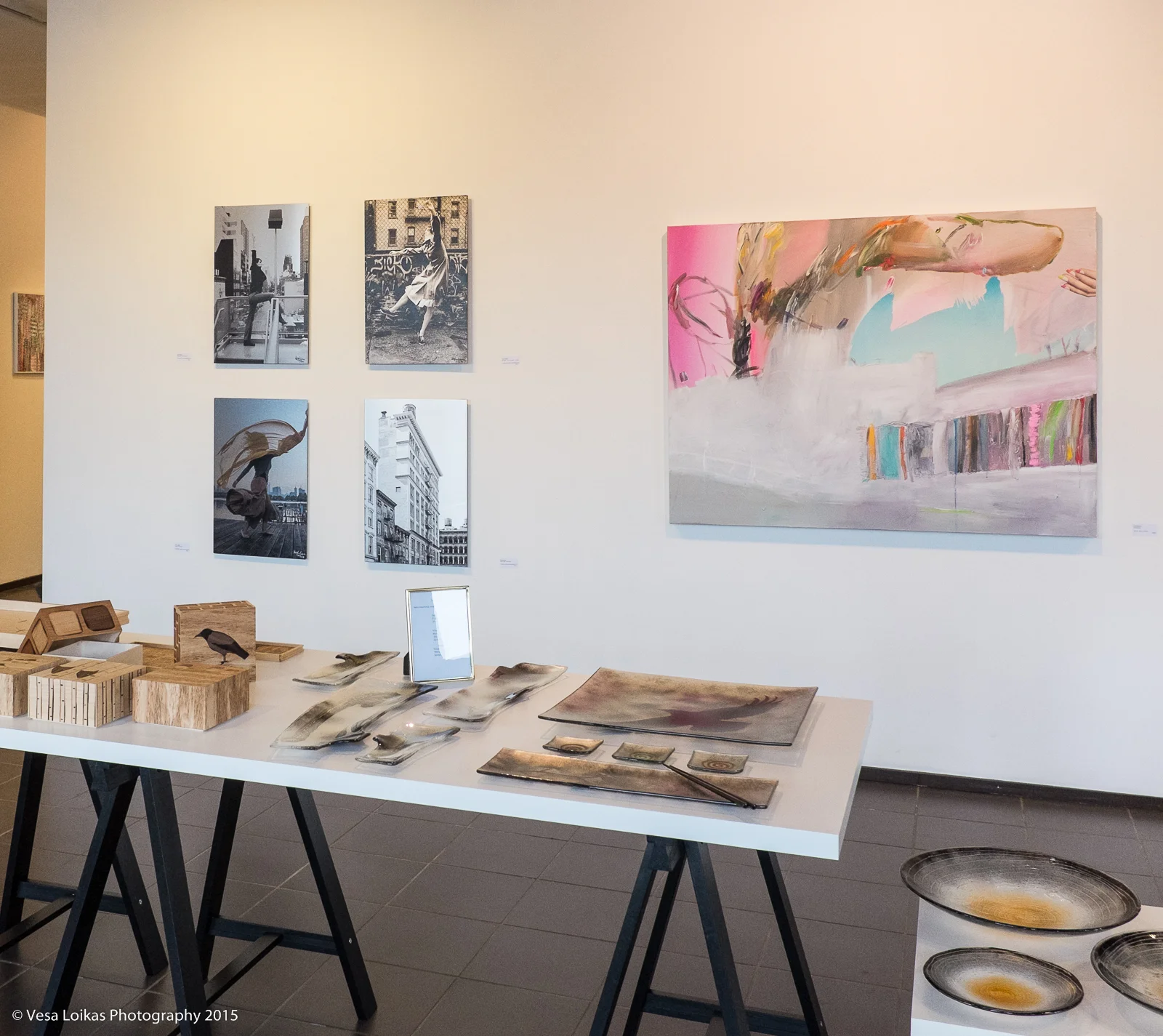 My photography next to Jani Rättyä's acrylic painting on the wall. On the table are works by Kirsi Laitinen and Sara Ilveskorpi.