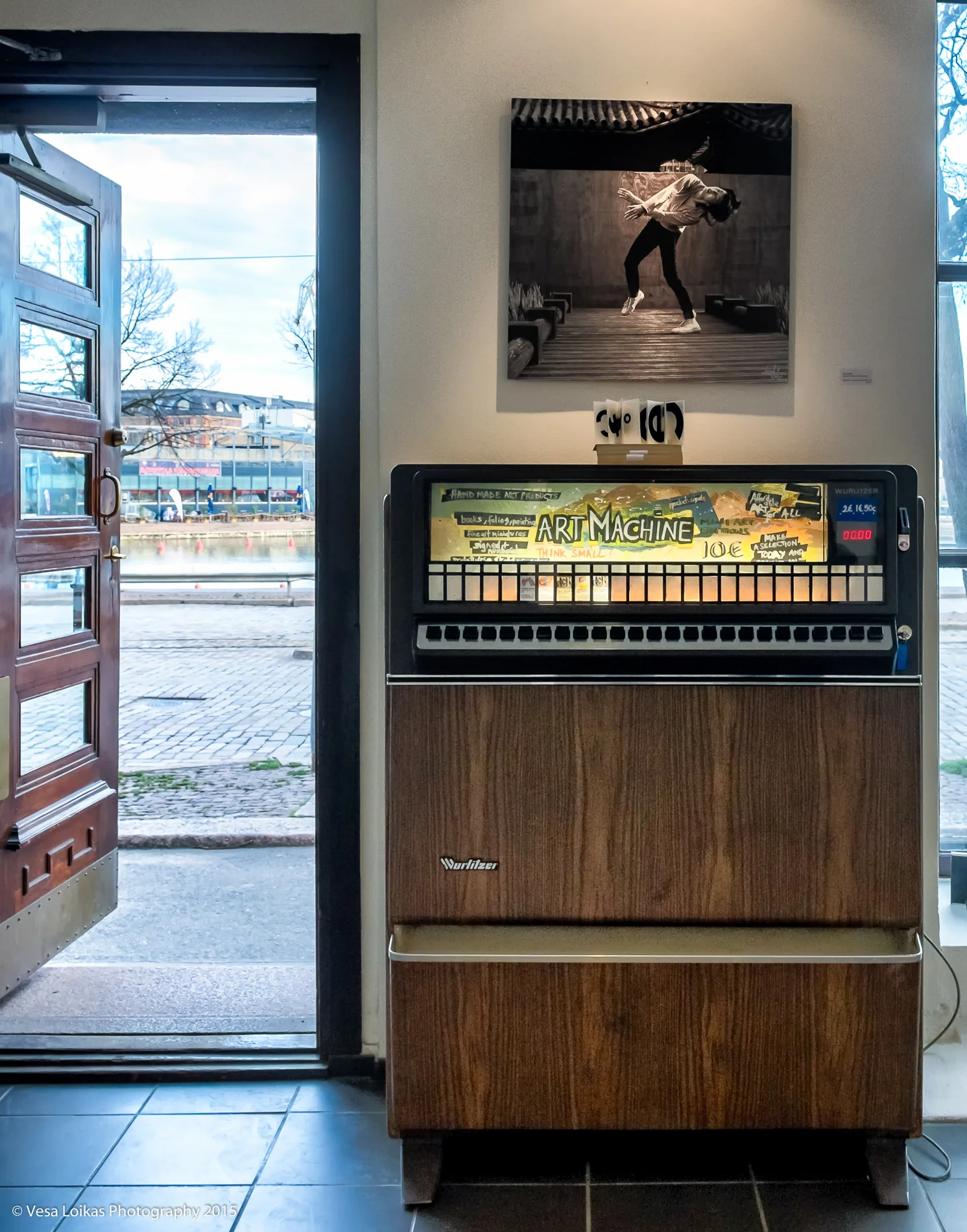 Art vending machine by the front door with my 'CHARACTER DANCER | SHANGHAI 2014' photograph on 60 x 60 cm brushed aluminum above.