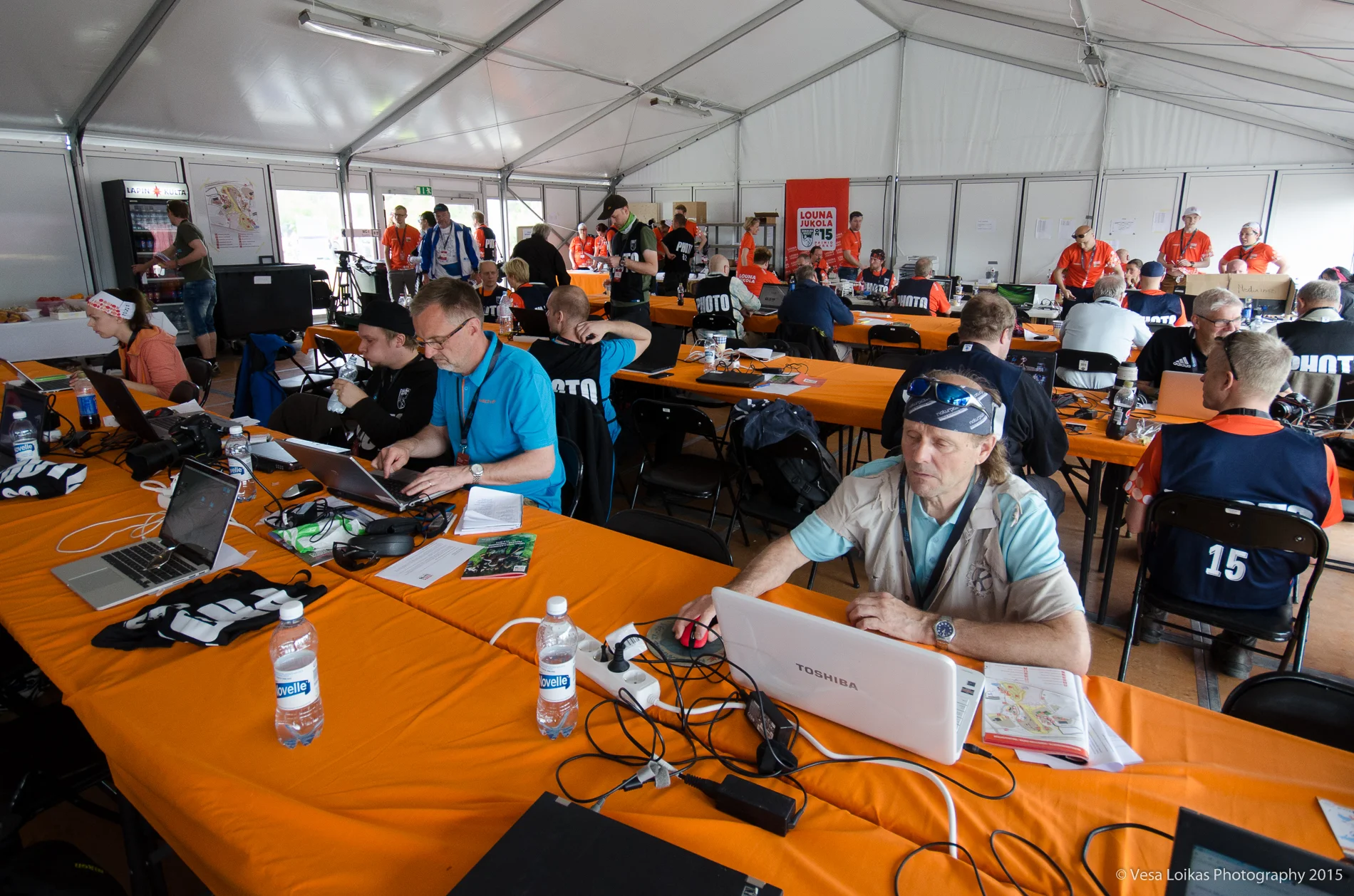 Media tent with journalists and photographers as well as webcast and social media crew.