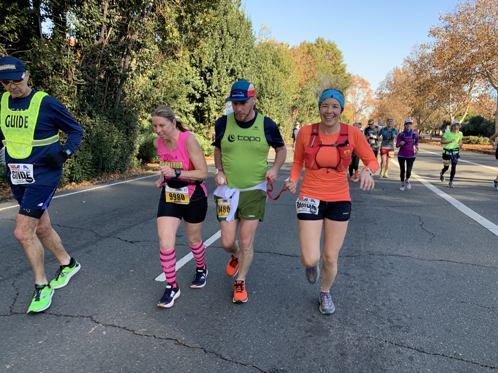 Sablle guiding Kyle. Kyle encouraging another runner from our community.