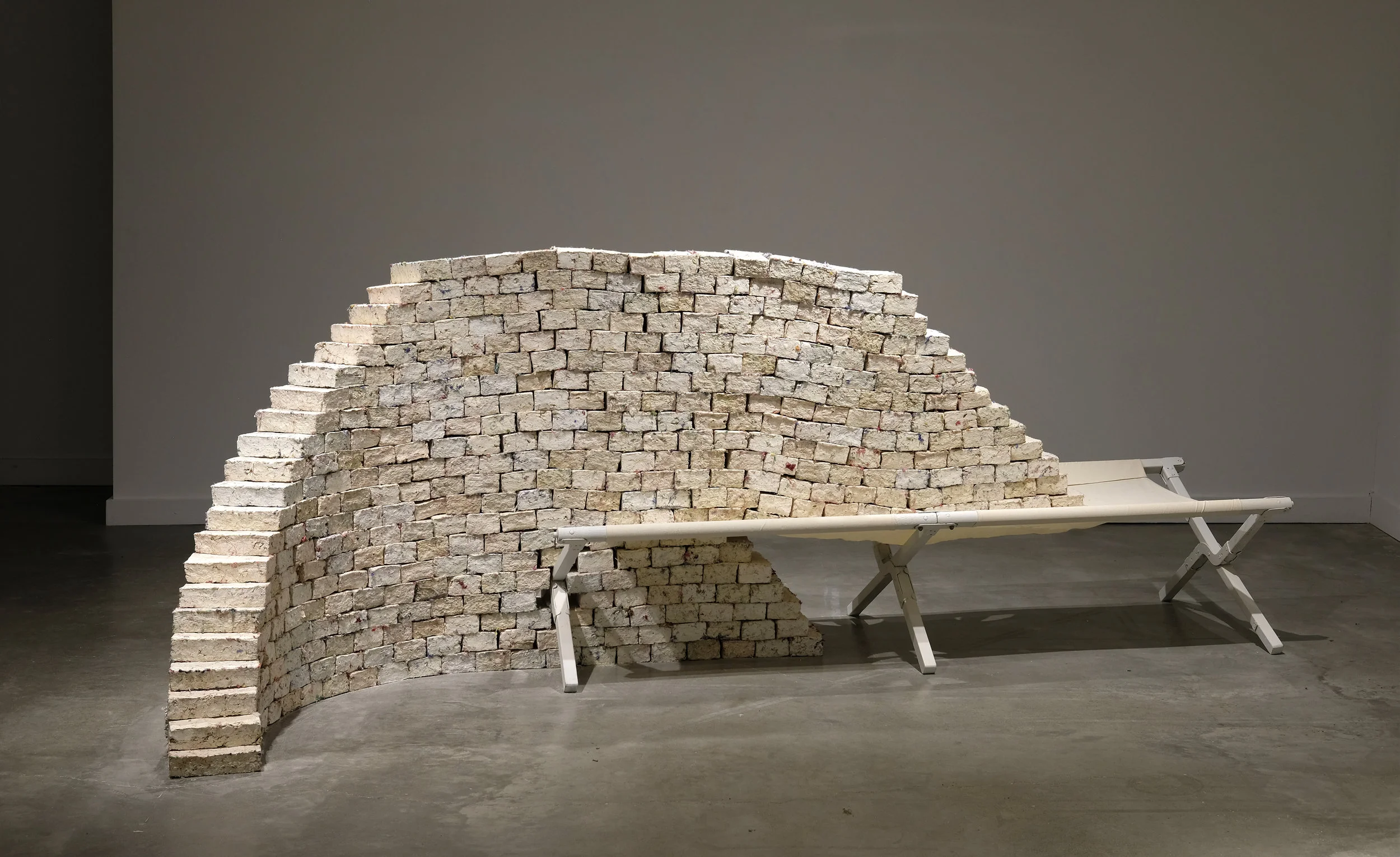 Sur/rendered 2017 unfired porcelain, pulverized afghan blankets, wallpaper paste, army cot photo by Bill Randall.