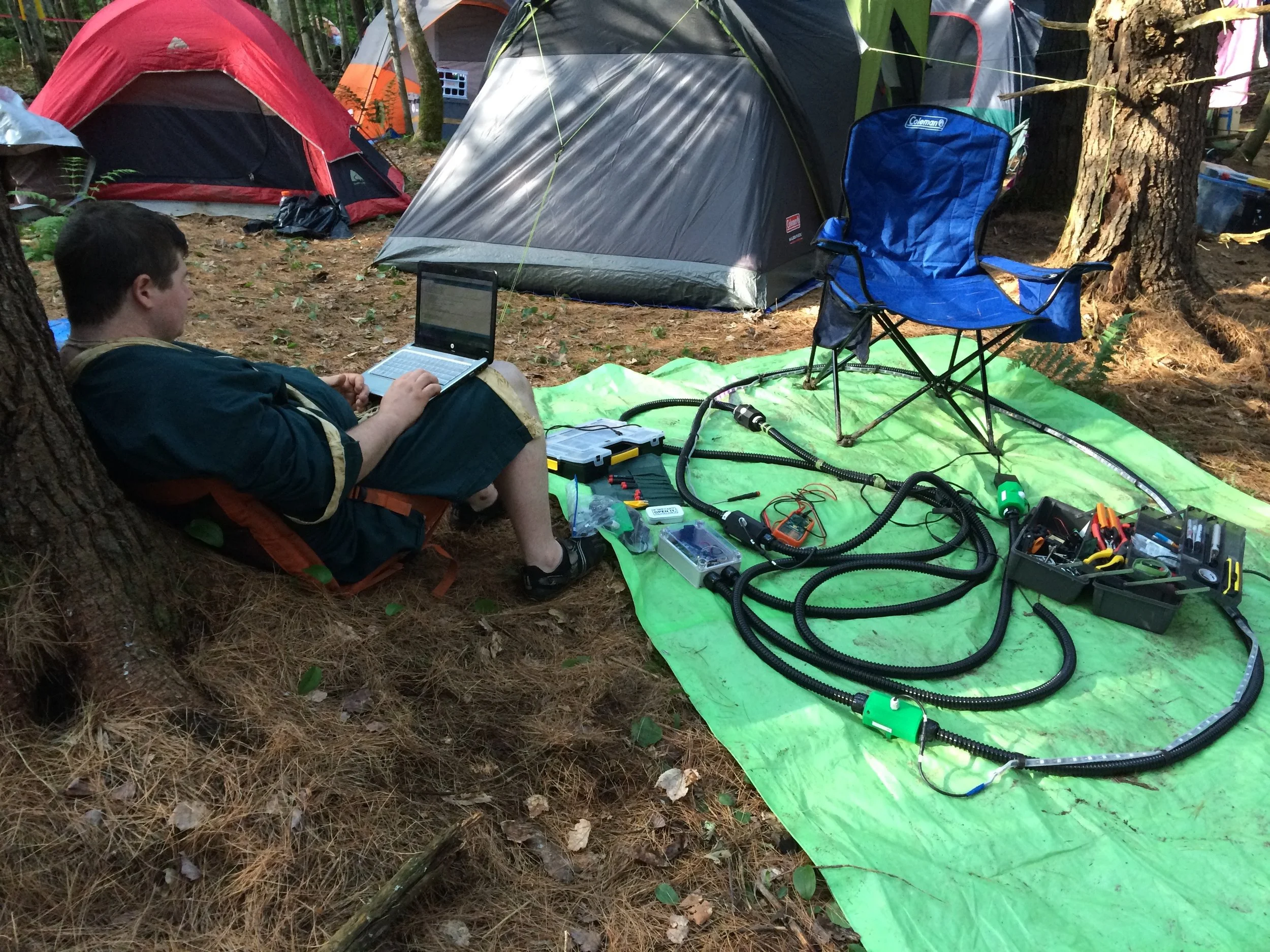 The Arduino brain of the Witch Lights is programmed using a hand-me-down linux netbook, because that's what I'm willing to risk bringing into the woods to be rained on. Shown above is my friend Scott, who was reviewing my first draft amateur