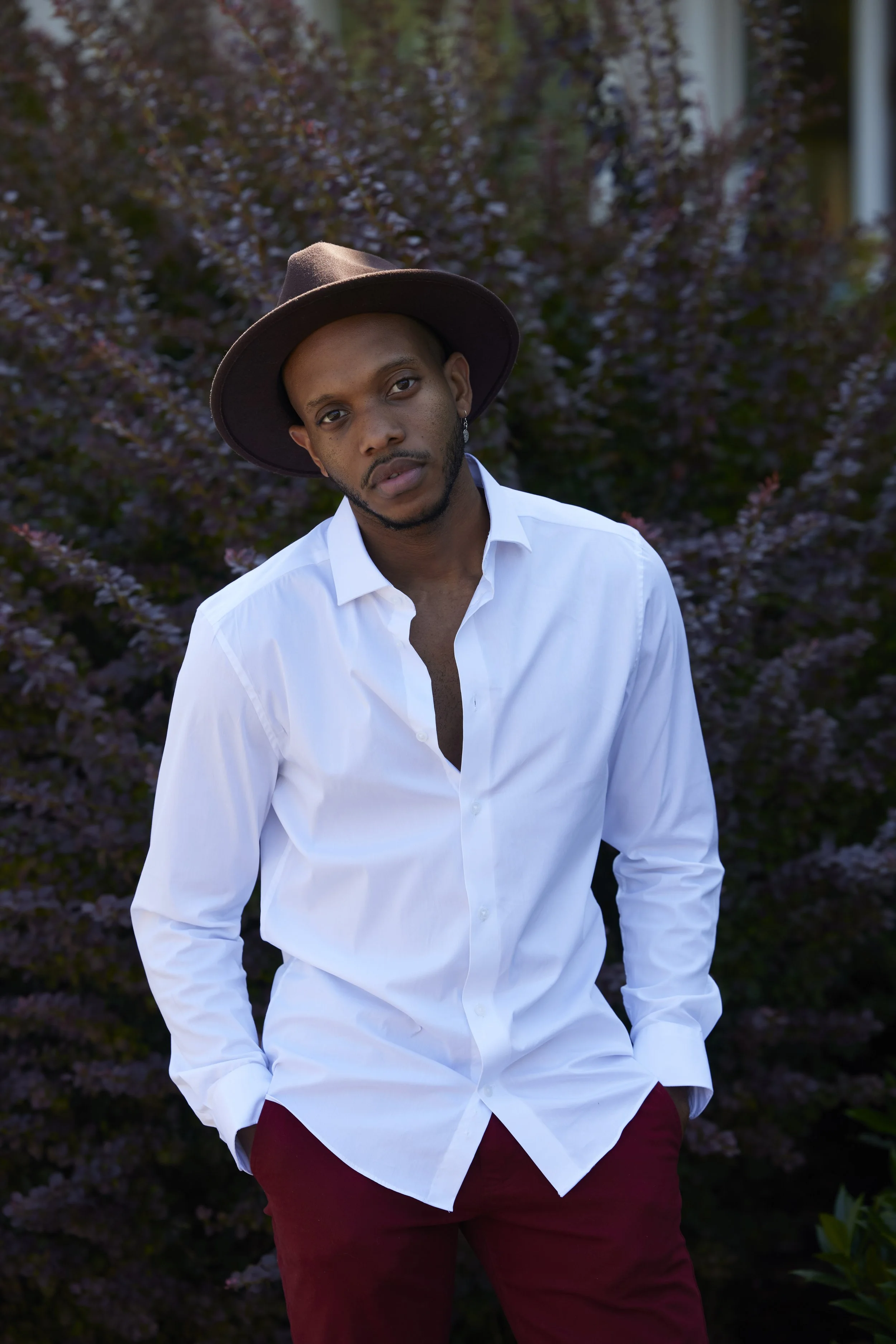 Men’s Portrait in White Shirt and Hat with Natural Backdrop