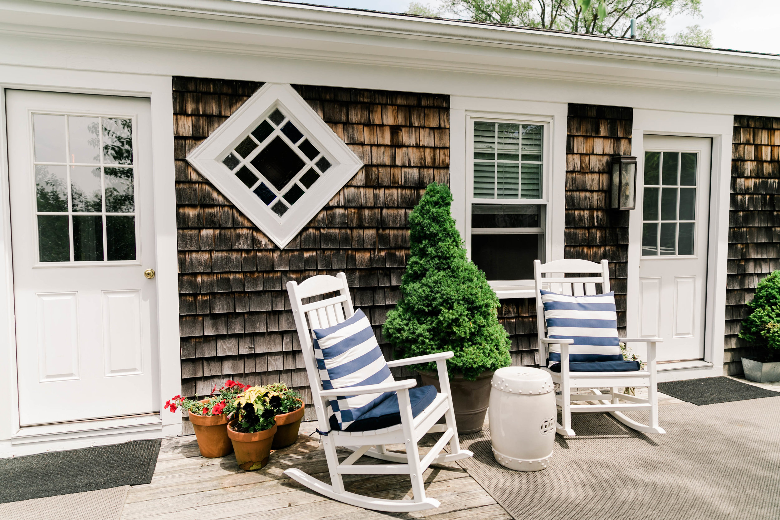 Cape Cod Style house exterior with rocking chairs