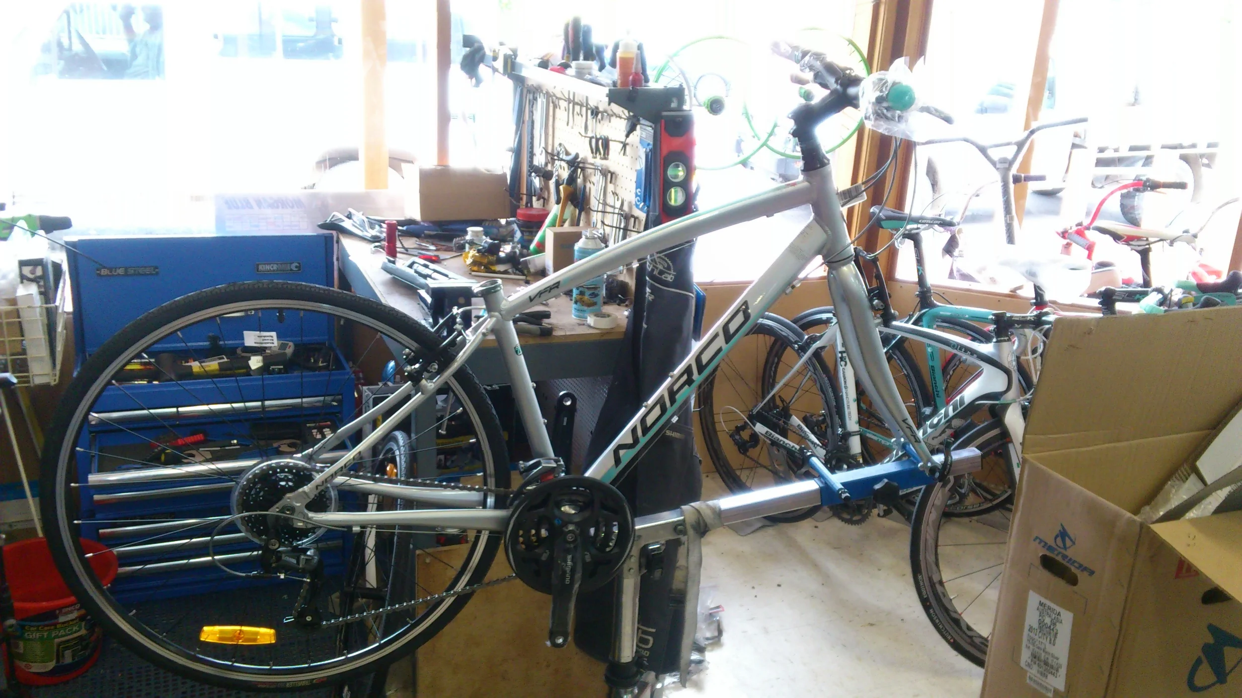 Bike ready for pedals and other parts. In the back gorund is our fully equipped workshop. This enables us to build and service most bike. By the way it is against Australian consumer starndards to sell a bike unassembled.