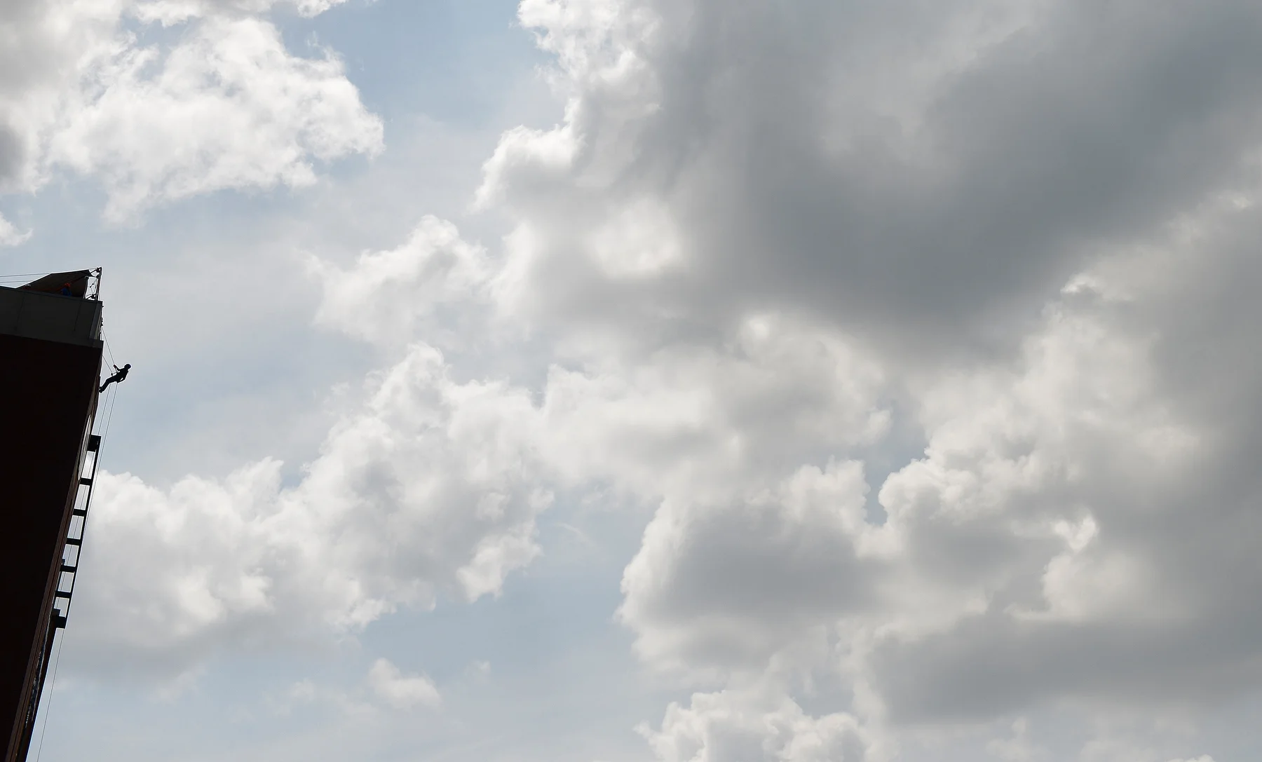 A man rappels down the west side of Lambeau Field, an event called the 'Ultimate Lambeau Leap' that raised money for Special Olympics Wisconsin in Green Bay Wis. on Saturday, Aug. 9, 2014. 