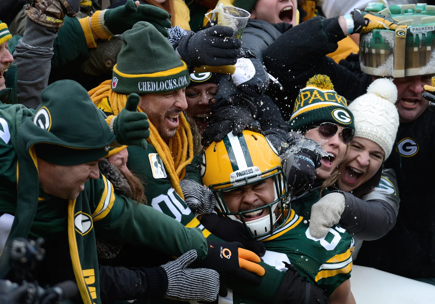  A fan spills beer on Green Bay Packers tight end Richard Rodgers (89) during his fourth quarter Lambeau leap. The Green Bay Packers defeated the Dallas Cowboys 26-21 in an NFC divisional playoff at Lambeau Field in Green Bay, Wis. on Sunday, Jan. 11