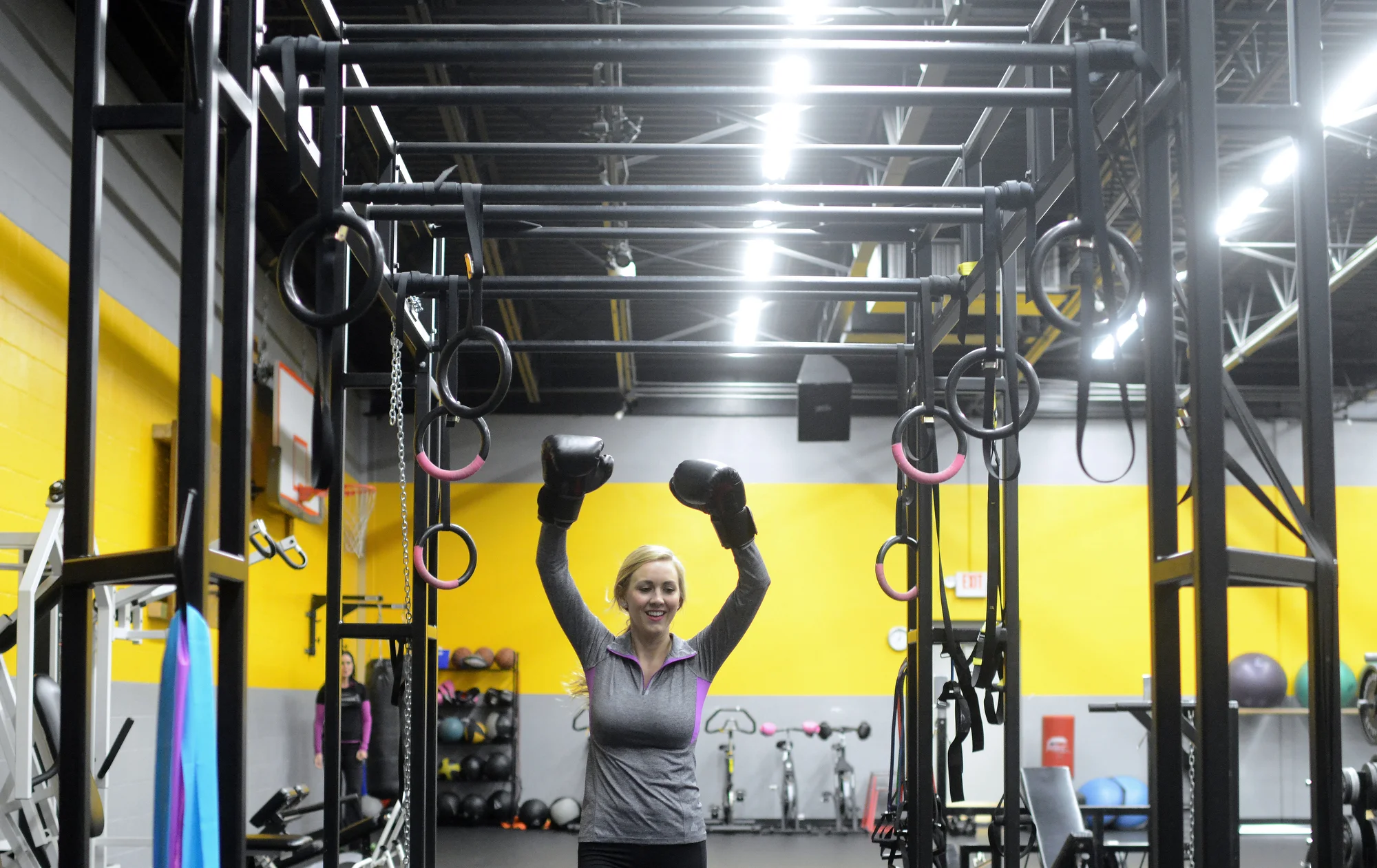  Miss Green Bay Area 2015 Jennie Collins runs a lap around Pro Fitness Incorporated while holding boxing gloves above her head. Pro Fitness sponsors the pageant by donating personal training sessions with Lisa Wauters to the winner of the contest. Ph