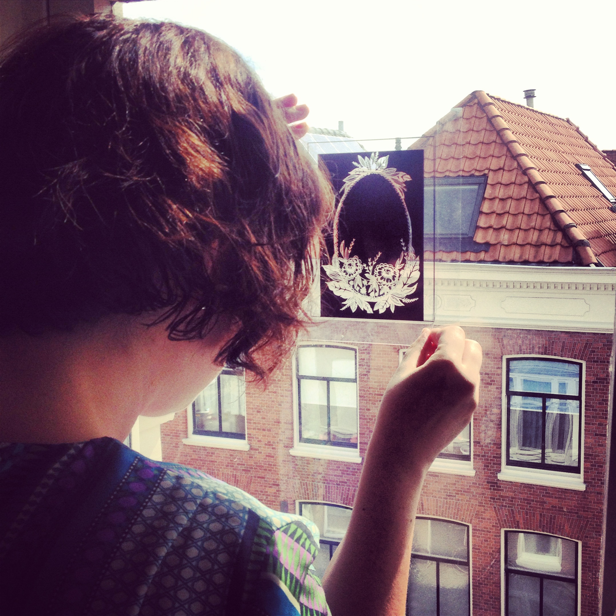 Working in the top room of the house, Anna aligns the films against the window, using it as a make-shift light-box.