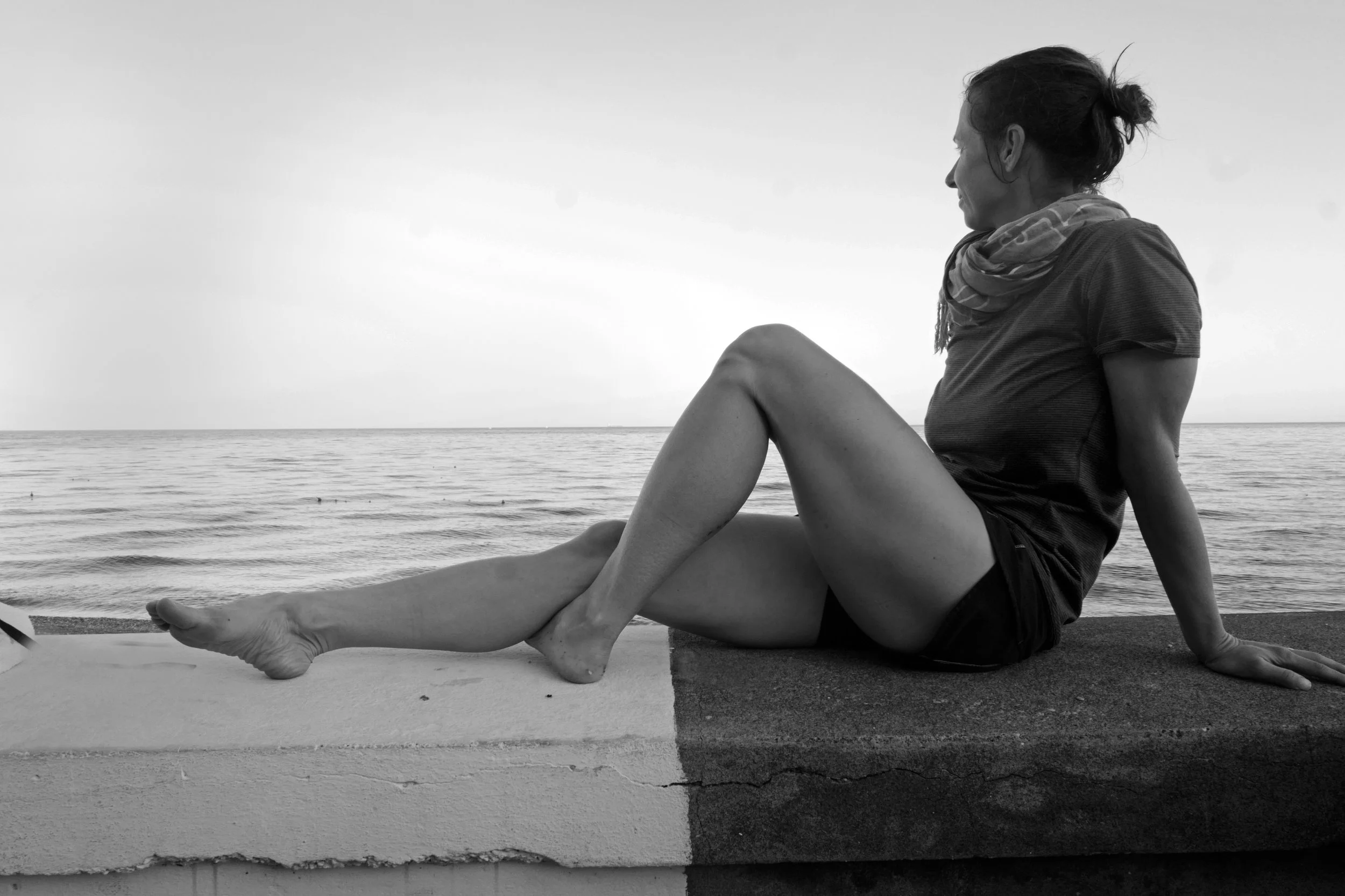 Woman Reclining on Seawall, Sicily