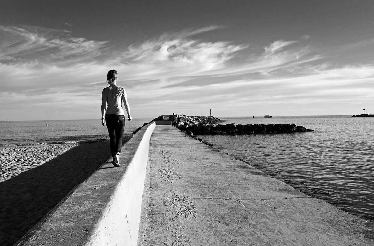 Woman Walking in Seawall, Corona Del Mar, California