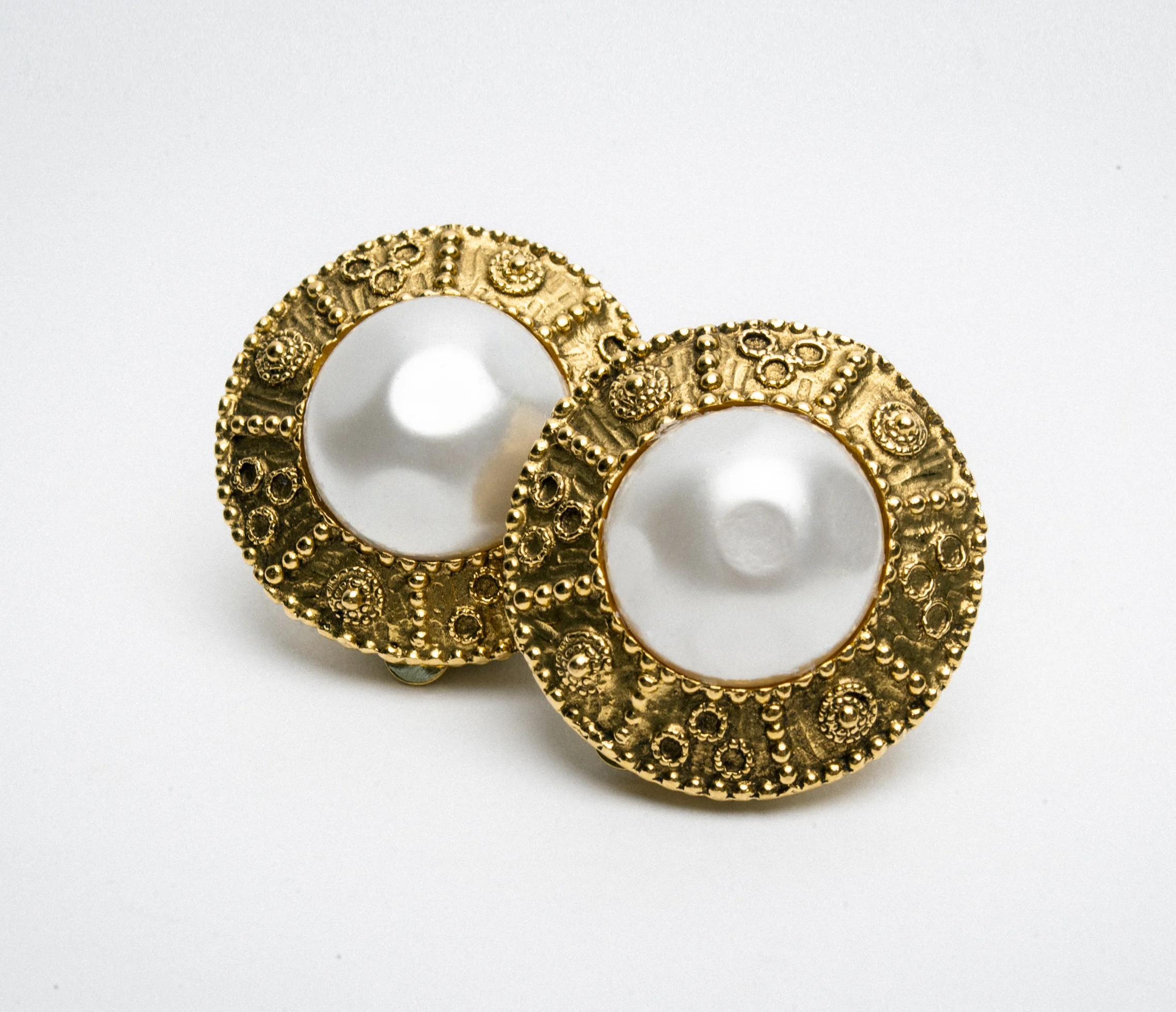 Gold and pearl decorative round earrings with intricate design