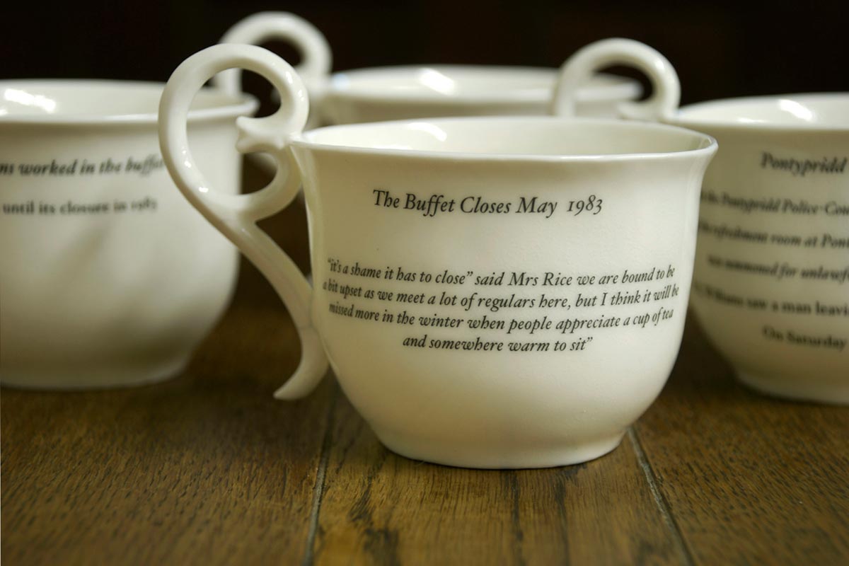 Fired bone china, slip cast cups, with decals. Inscription from archived local Newspapers. 
