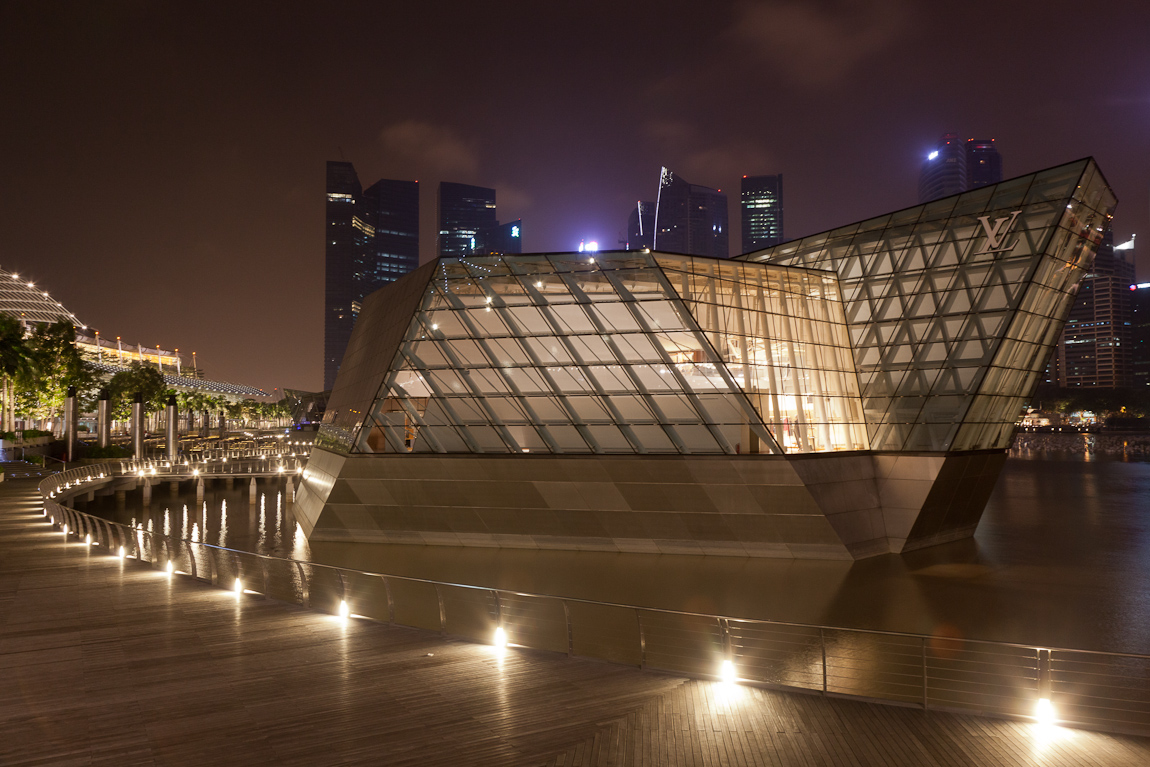 Today the Marina Bay Sands light crew took a day off from practicing for Countdown 2012, so I looked for other subjects along the boardwalk. This is the Louis Vuitton shop which appears to float in the bay, with the tall buildings of the Marina Bay Financial Centre, The Sail, One Raffles Quay, Ocean Financial Centre, etc. in the background. (Also on Google+)