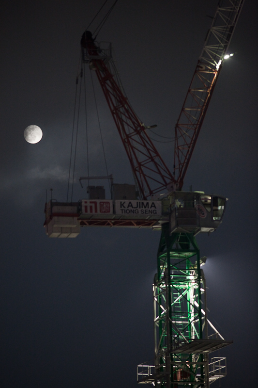 A loud noise from the construction site next door drew my attention to the window this evening in time to capture this view of the full moon, here in Marina Bay, Singapore.